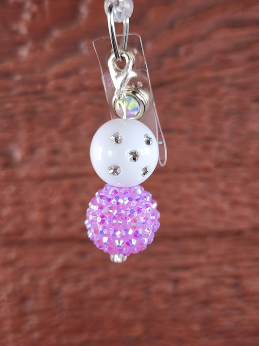 White and purple badge reel bead charm